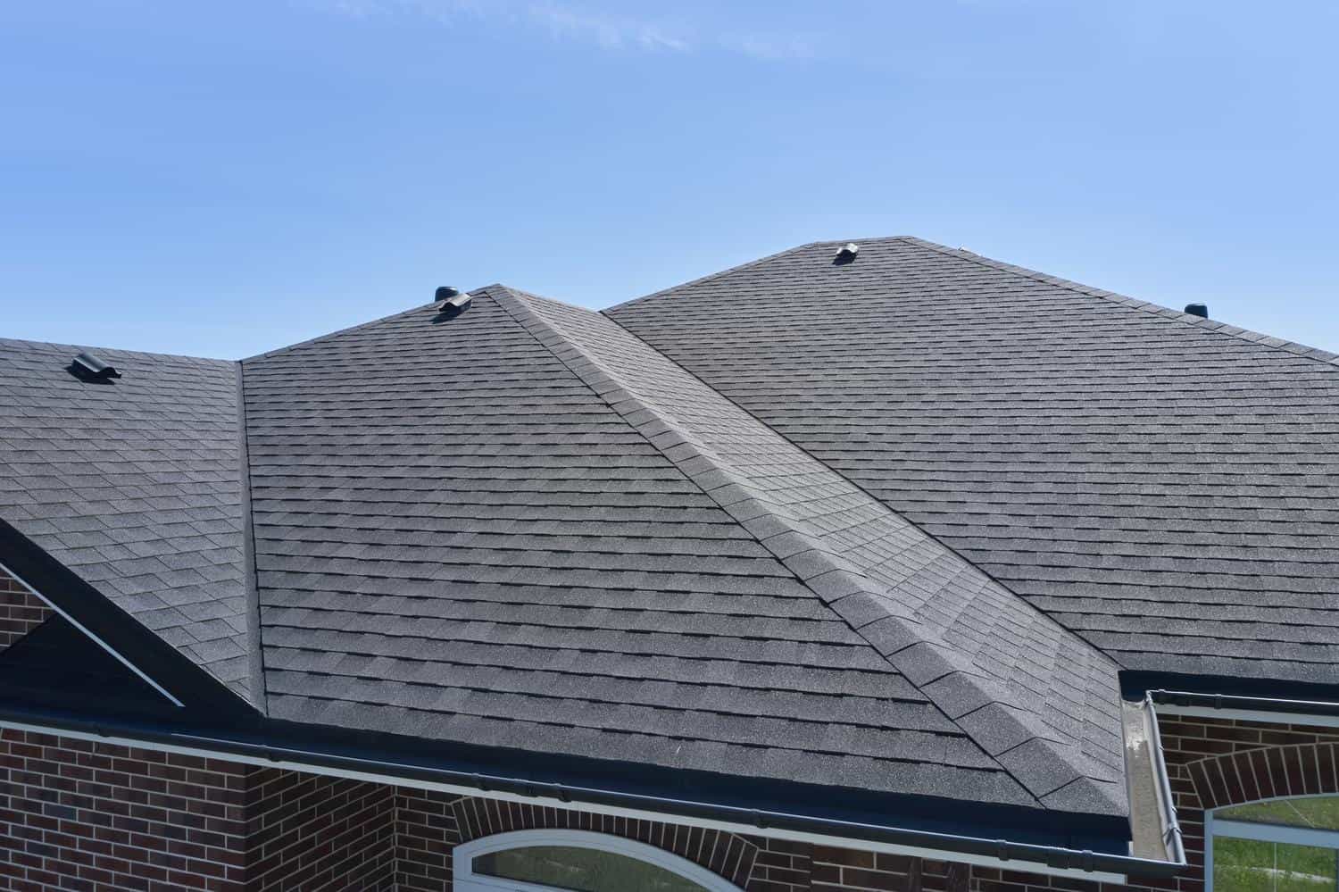 Roofer installing asphalt shingles on a home