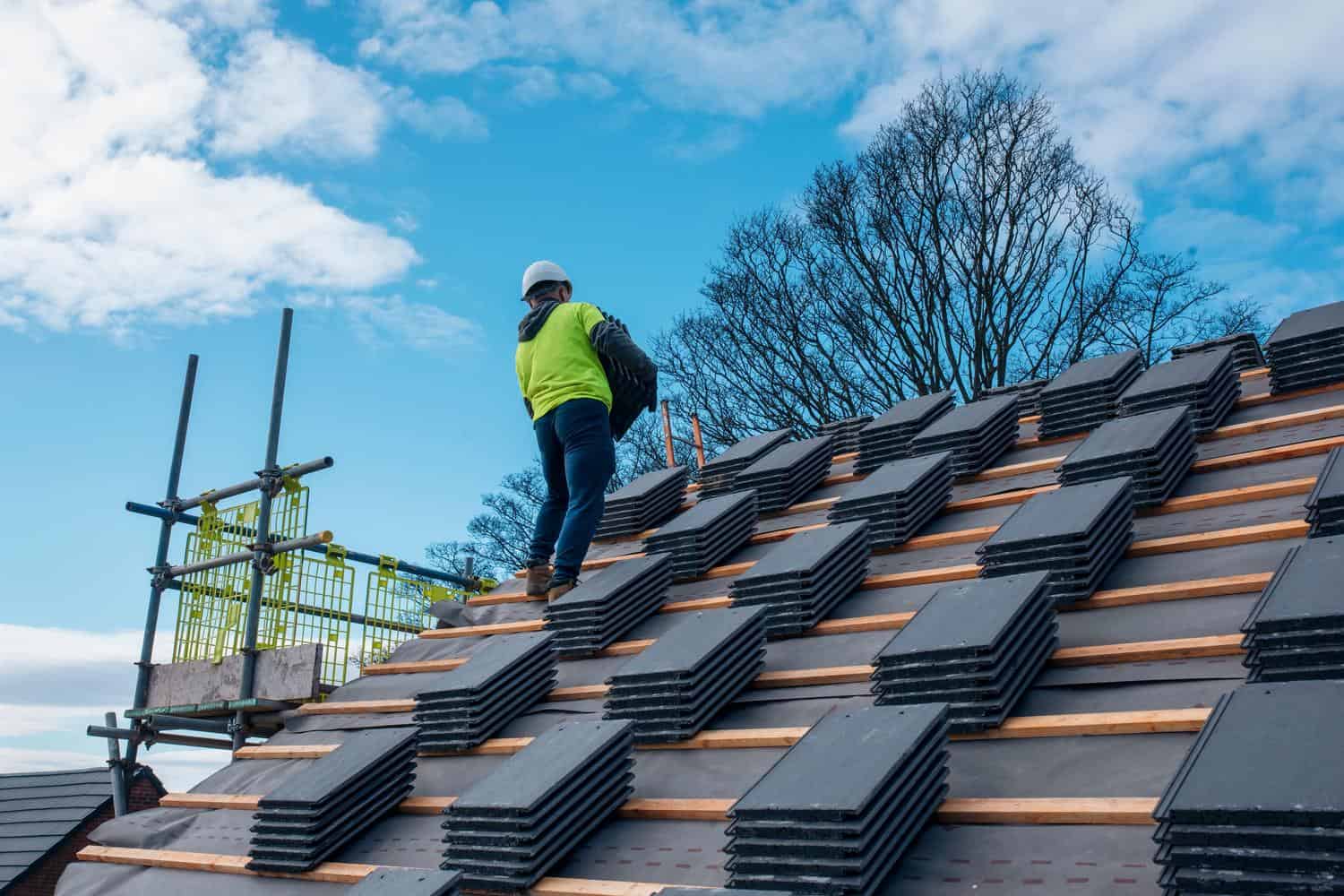 Roofer replacing a storm-damaged roof