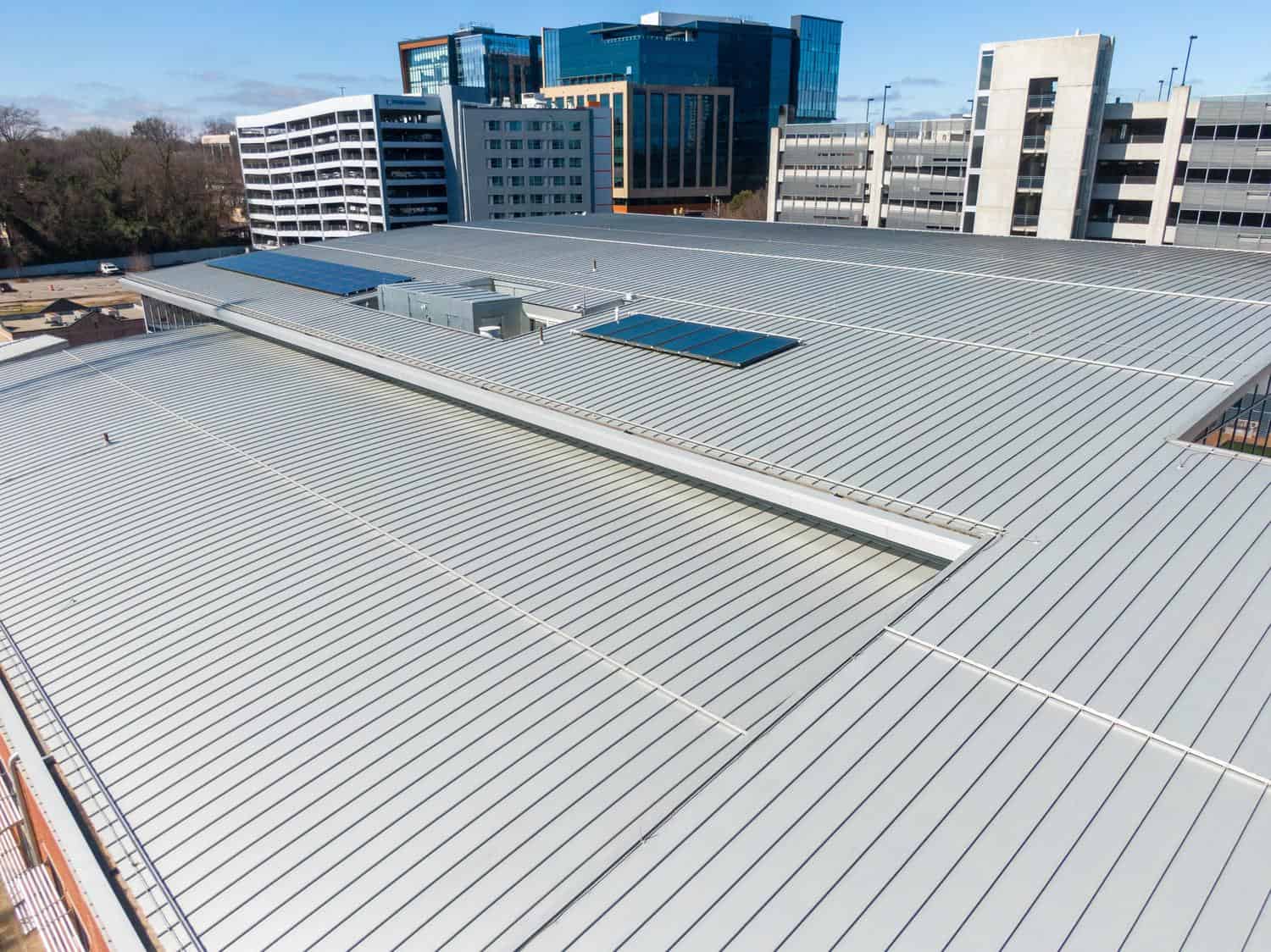 Metal roof on a commercial building with offices behind it