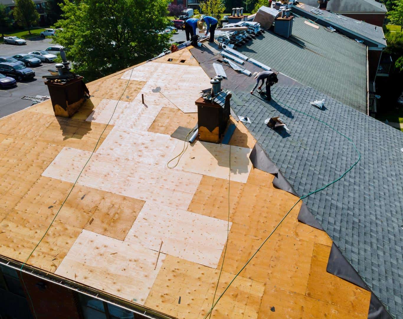 Roof replacement underway with workers installing new roofing materials in Monument, Colorado.