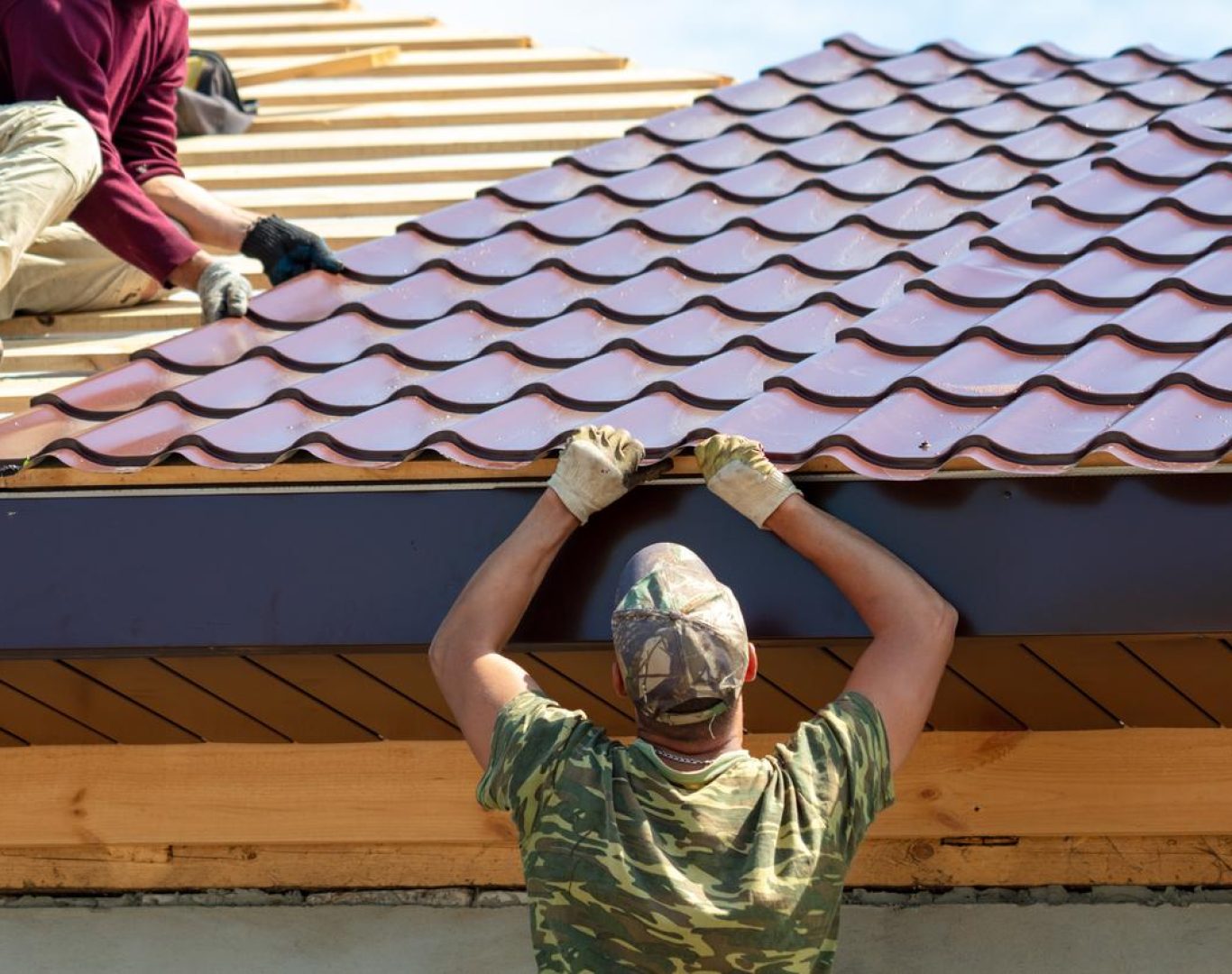 Roofing company in Arvada, CO installing composite shingles on a suburban home