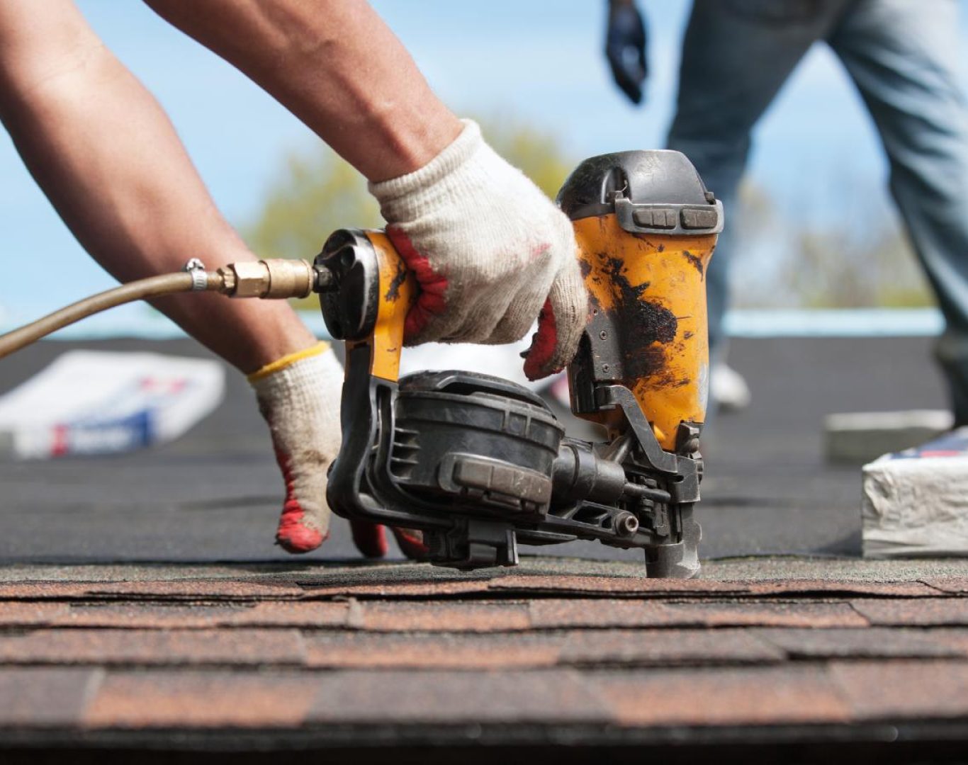 Roofing company in Jefferson County, CO installing shingles on a suburban home