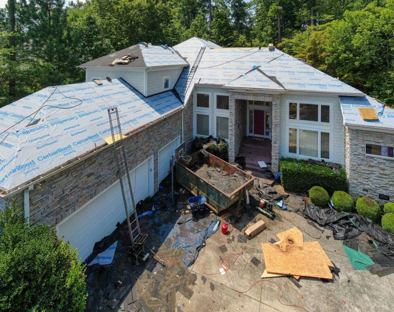 Roofing company in Monument, CO installing shingles during a winter project